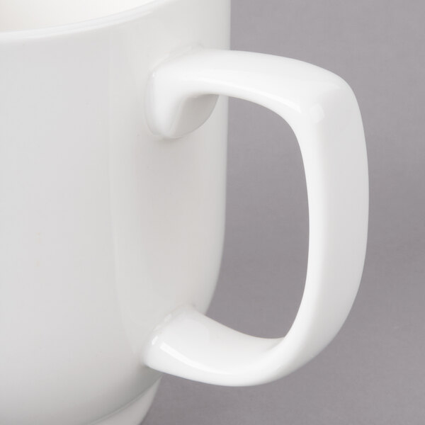 A white Bon Chef porcelain cup with a handle.