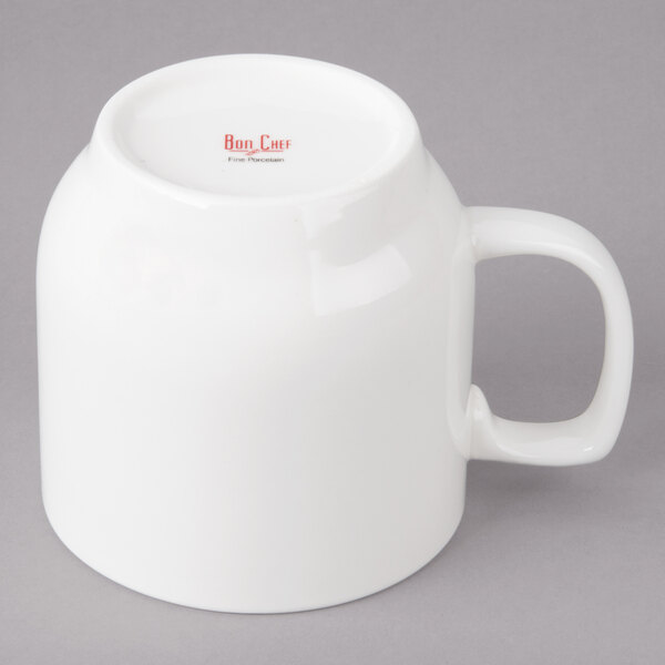A white Bon Chef porcelain cup with a handle.