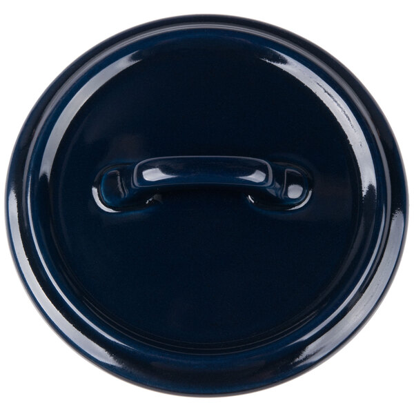 A cobalt blue porcelain lid with a handle.
