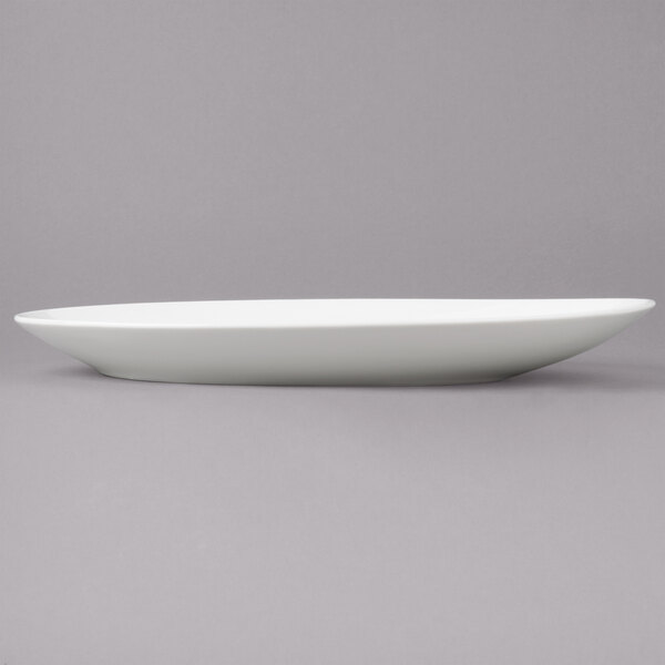 A Bon Chef white porcelain plate with a slanted long edge.