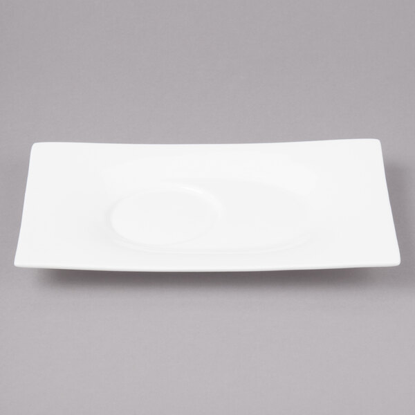 A white rectangular saucer with a circular edge.