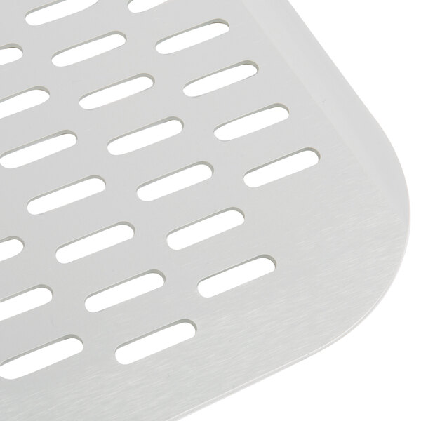 A close up of a white metal square with a long white handle and perforations.