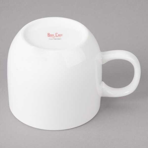 A close-up of a white Bon Chef porcelain cup with a handle.
