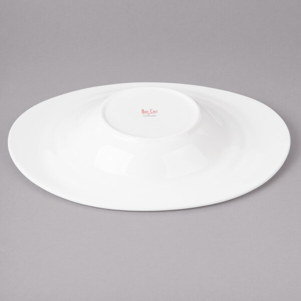A white porcelain oval pasta bowl with concentric circles in white on the bottom.