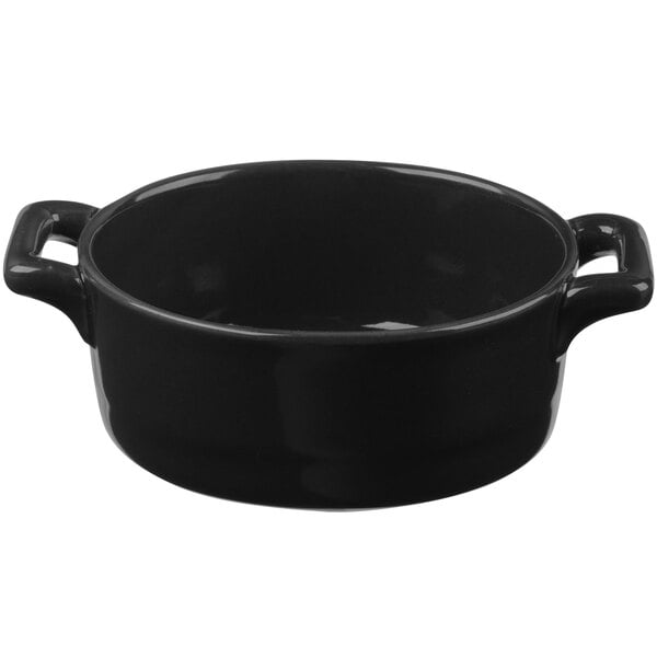 A matte black porcelain oval cocotte with handles.