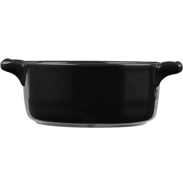 A black porcelain oval cocotte with handles.