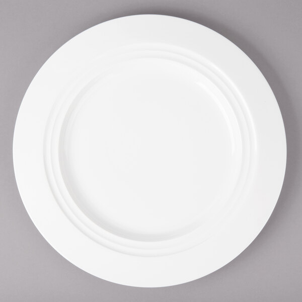 A Bon Chef white porcelain charger plate with a rim.