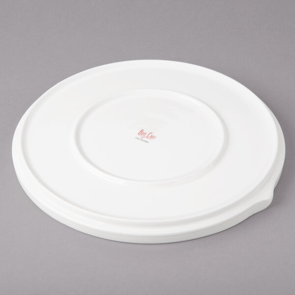 A white porcelain dinner plate with stacked line design.
