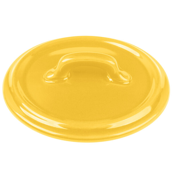 A yellow Bon Chef porcelain lid with a handle.