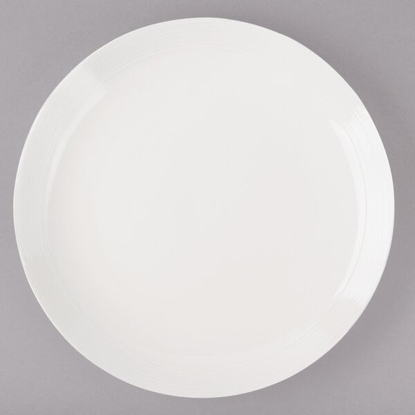 A white Bon Chef porcelain dinner plate with a white rim.