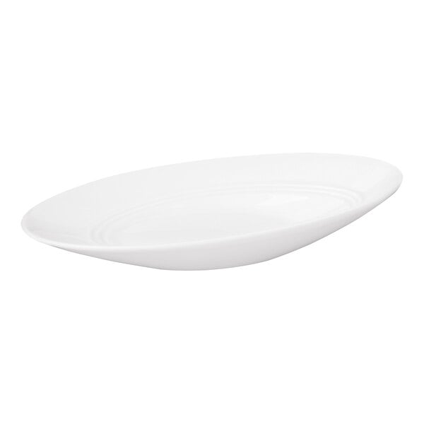 A white, oval-shaped porcelain bowl with a slanted rim and a smooth, glossy finish.