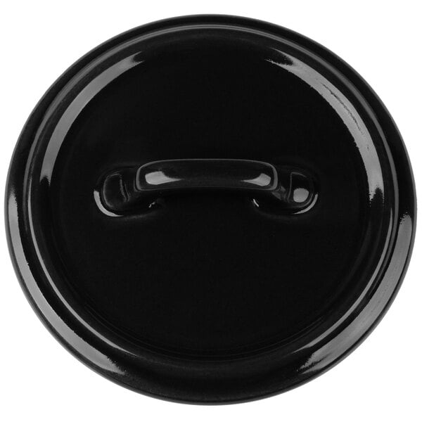 A black Bon Chef porcelain cocotte lid with a handle.