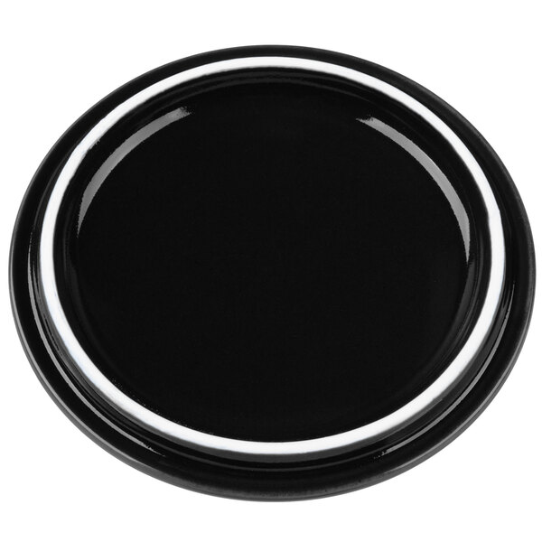A black porcelain lid with a white border.