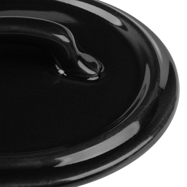 A Bon Chef matte black porcelain lid with a handle.