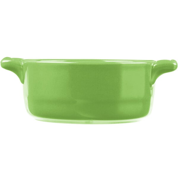 A green porcelain oval cocotte with handles.