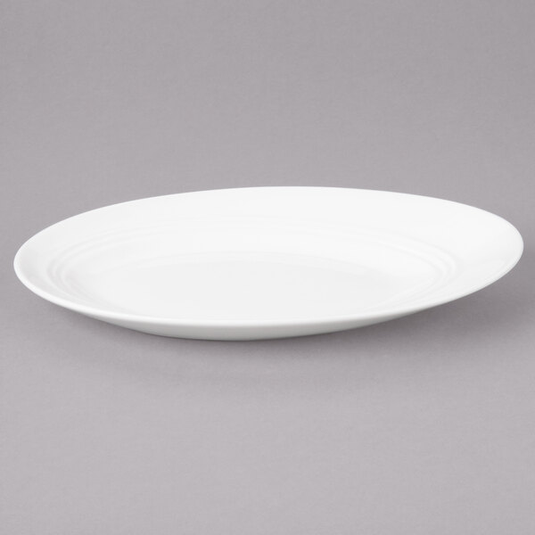 A white Bon Chef porcelain oval plate with a rim.