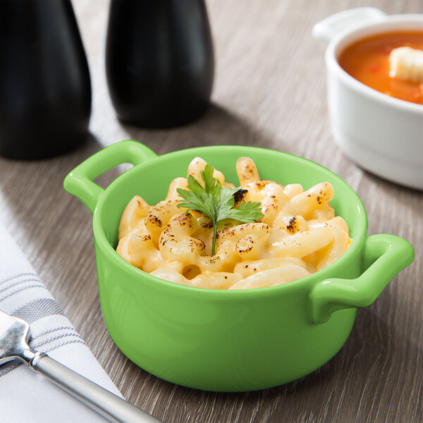 A lime green Bon Chef porcelain cocotte filled with macaroni and cheese.