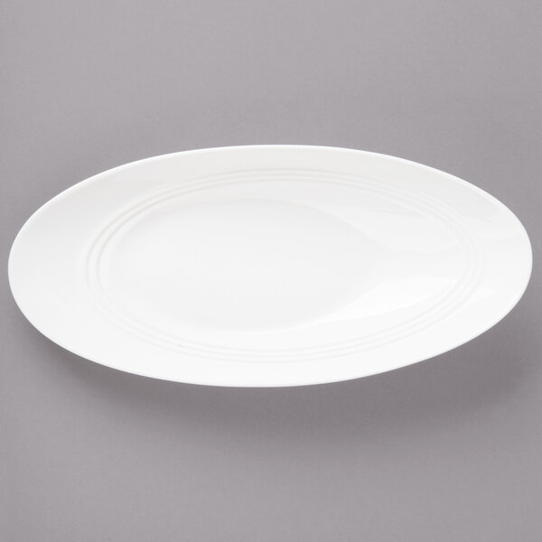 A white porcelain oval bowl with a curved edge.