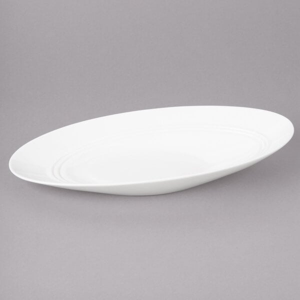 A white oval porcelain bowl with a rim.