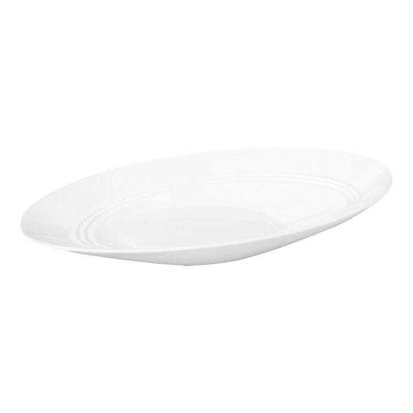 A white, oval-shaped porcelain bowl with a slanted rim and subtle concentric circle detailing.
