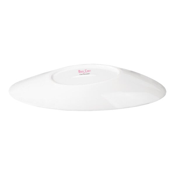 A white, oval-shaped porcelain bowl with a slanted design, shown from a low angle.