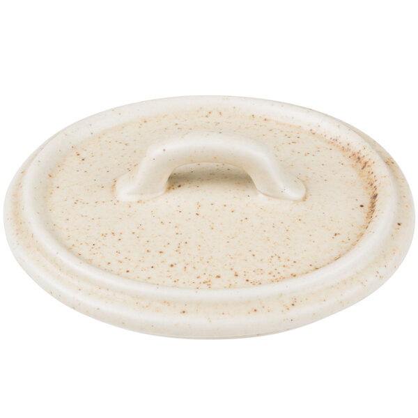 A white porcelain Bon Chef oval lid with a handle.