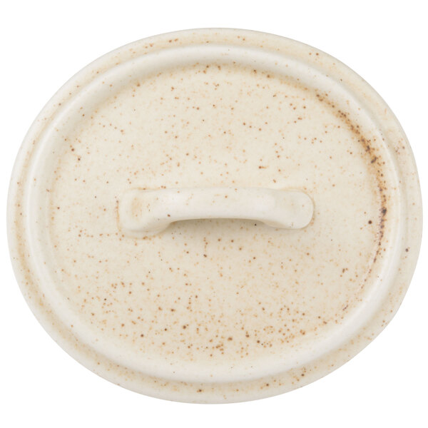 A white Bon Chef porcelain oval lid with a handle.