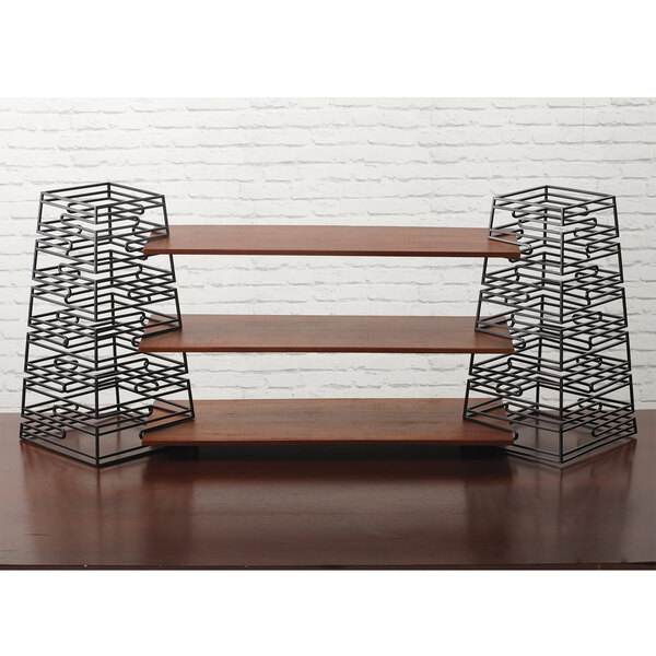 A black metal GET RISER-SET-L display shelf on wood slats.