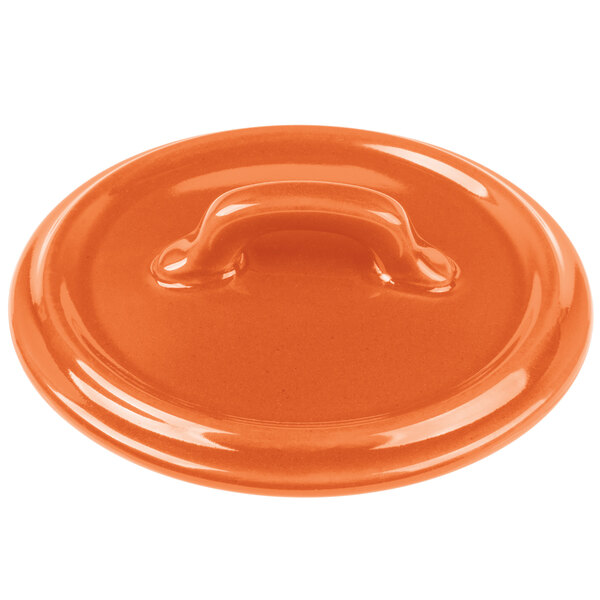 An orange Bon Chef porcelain lid with a handle.