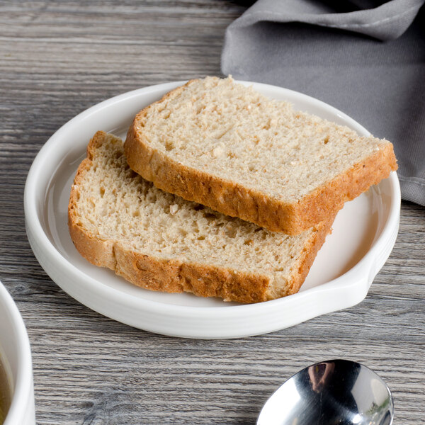 A slice of bread on a Bon Chef white porcelain bread and butter plate.