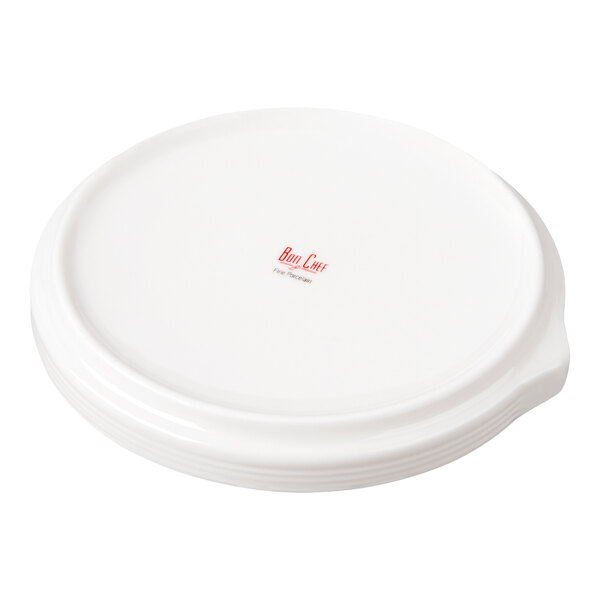 A stack of round, white plates with a small handle on the side and a red logo in the center.
