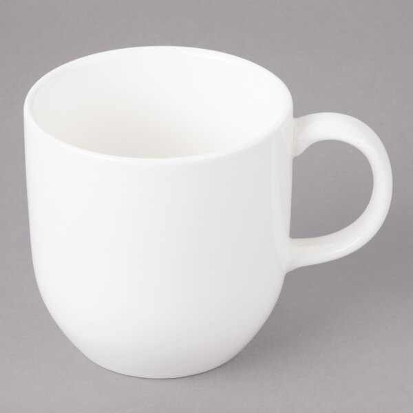 A white Bon Chef porcelain cup with a handle.