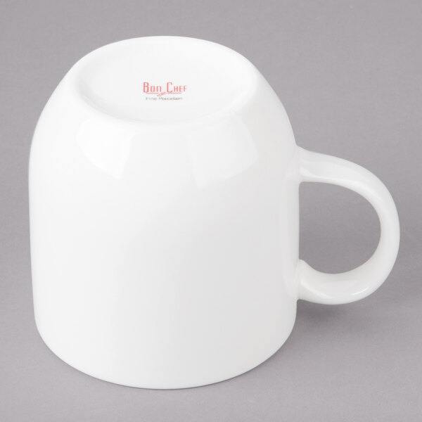 A white Bon Chef porcelain cup with a handle.