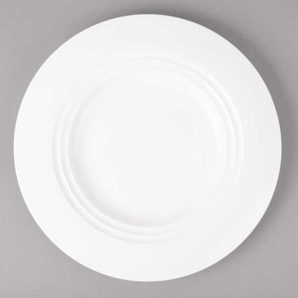 A Bon Chef white porcelain dinner plate with a rim.