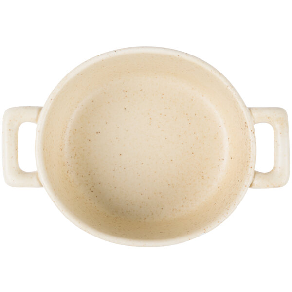 A white Bon Chef porcelain oval cocotte with handles.