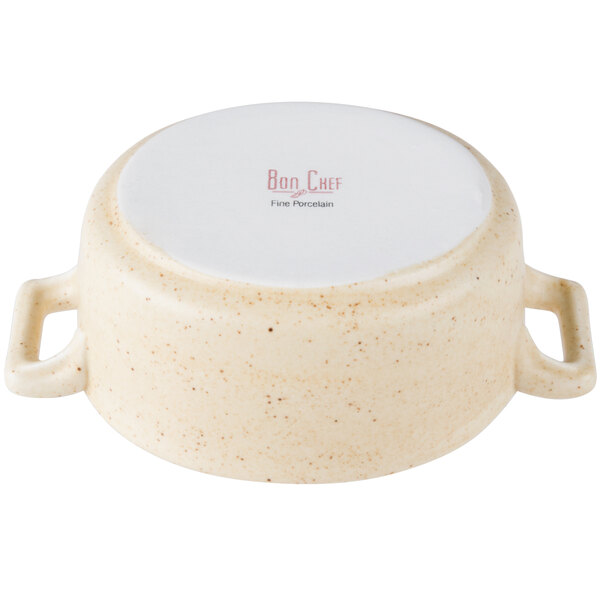 A white porcelain oval cocotte with handles.