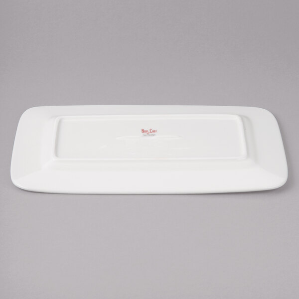 A white rectangular plate with red circles and writing.