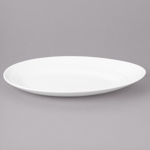 A white Bon Chef porcelain oval plate with a curved edge.