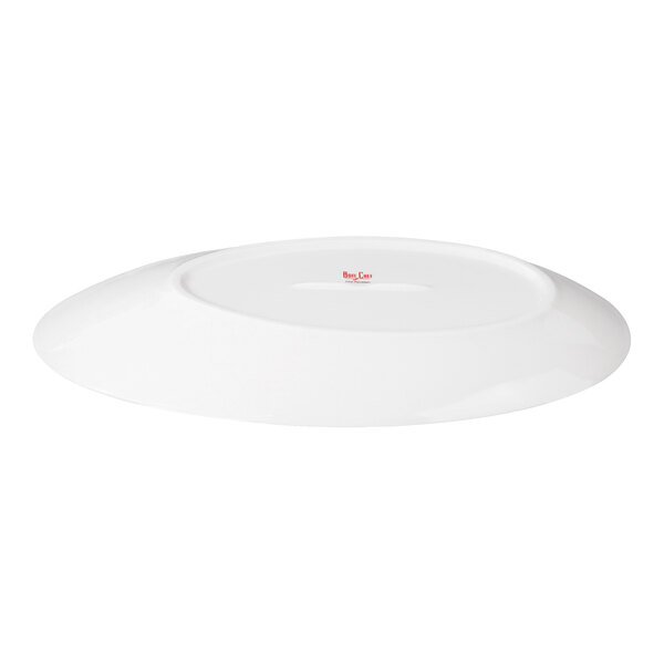 A white, oval-shaped porcelain plate shown from a low angle, highlighting its slanted design.