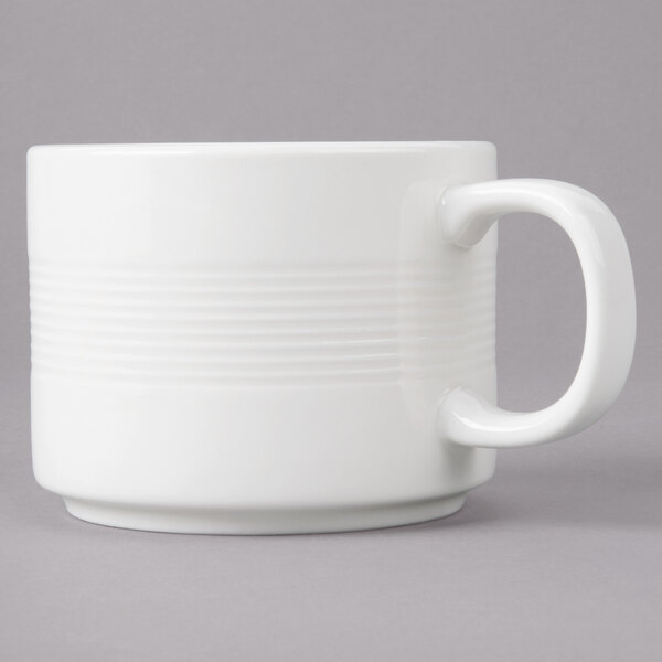 A white porcelain mug with stacked lines on the side and a handle.
