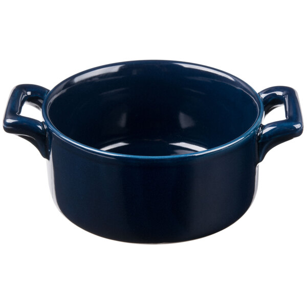 A cobalt blue porcelain cocotte with two handles.