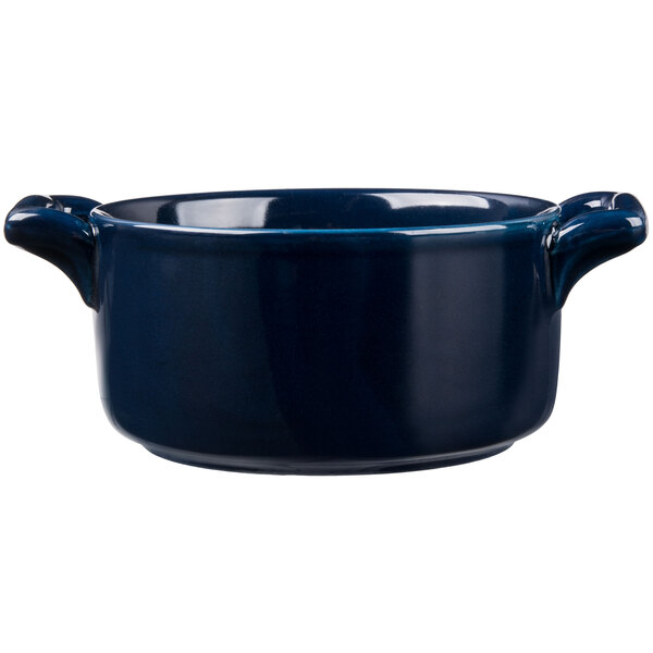 A cobalt blue porcelain cocotte with two handles.