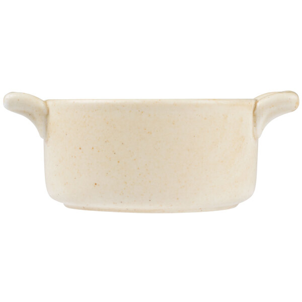 A white porcelain cocotte with two handles.