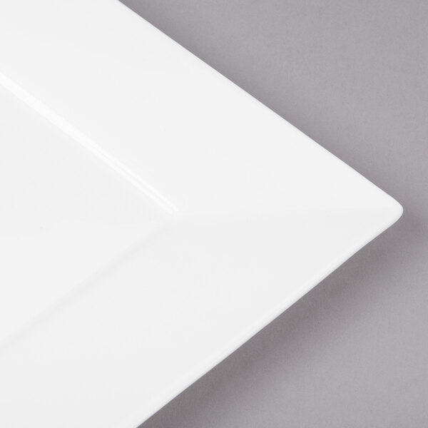 A close up of a white Bon Chef square bone china plate with a square edge.