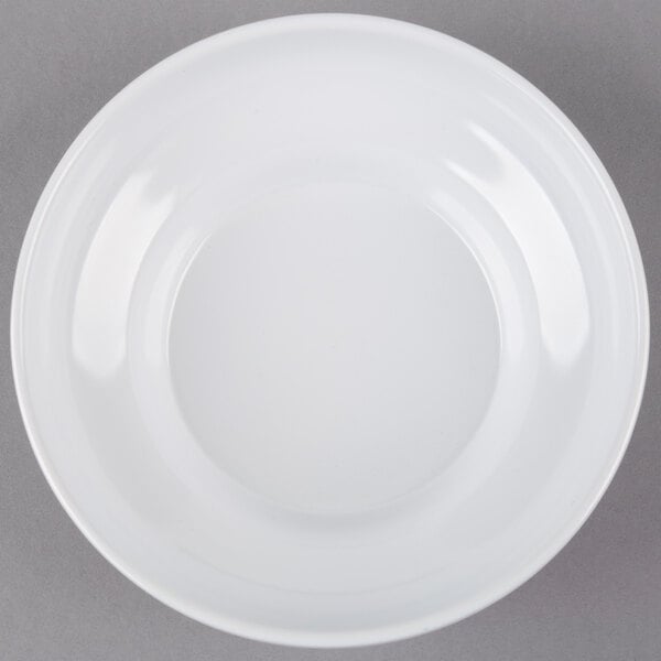 A white melamine bowl with a white rim on a gray background.
