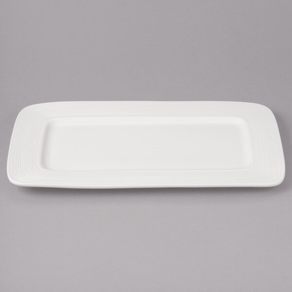 A white rectangular Bon Chef porcelain plate with thin black circles on the edge.