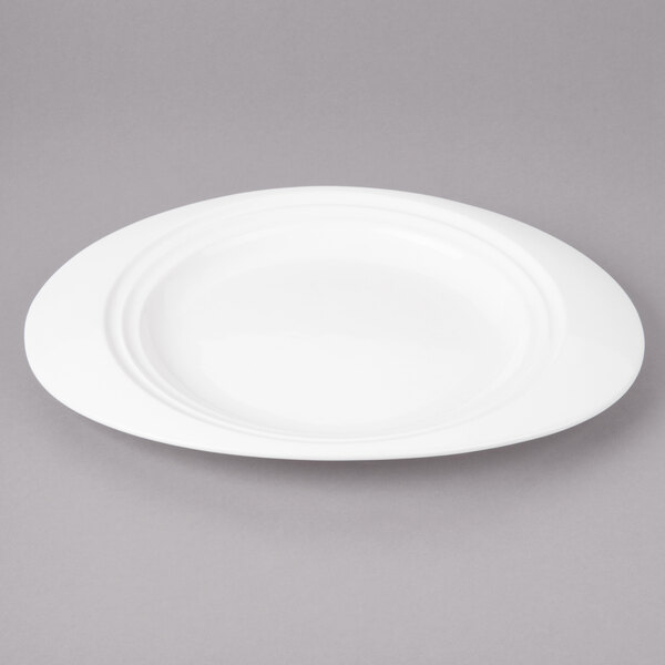 A white porcelain oval salad plate with a concentric design.