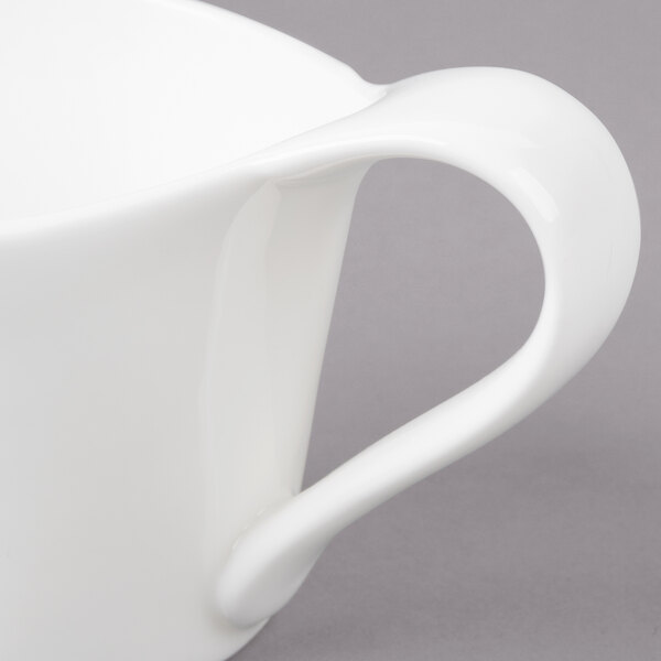 A close-up of a white Bon Chef espresso cup with a handle.