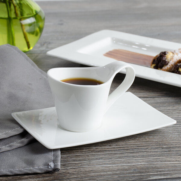 A white Bon Chef bone china espresso cup filled with coffee on a saucer.
