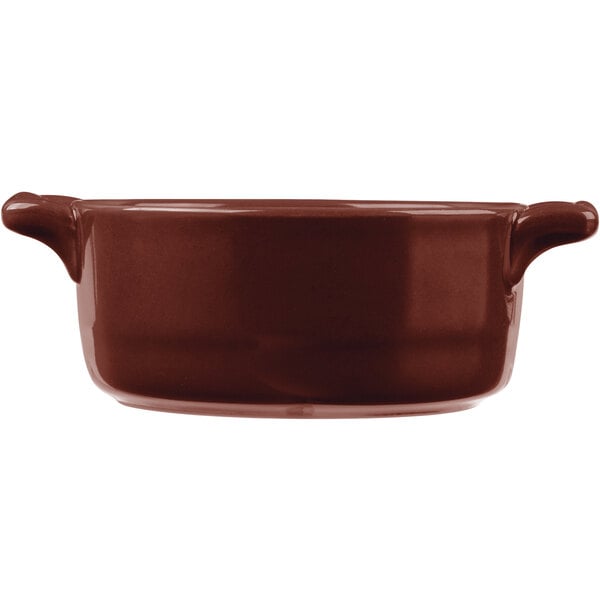 A brown Bon Chef porcelain oval cocotte with handles.